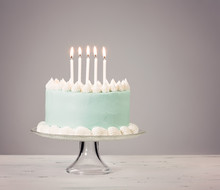 Blue Birthday Cake Over Grey Background.