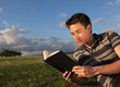 © kieferpix - Young man reading the bible.