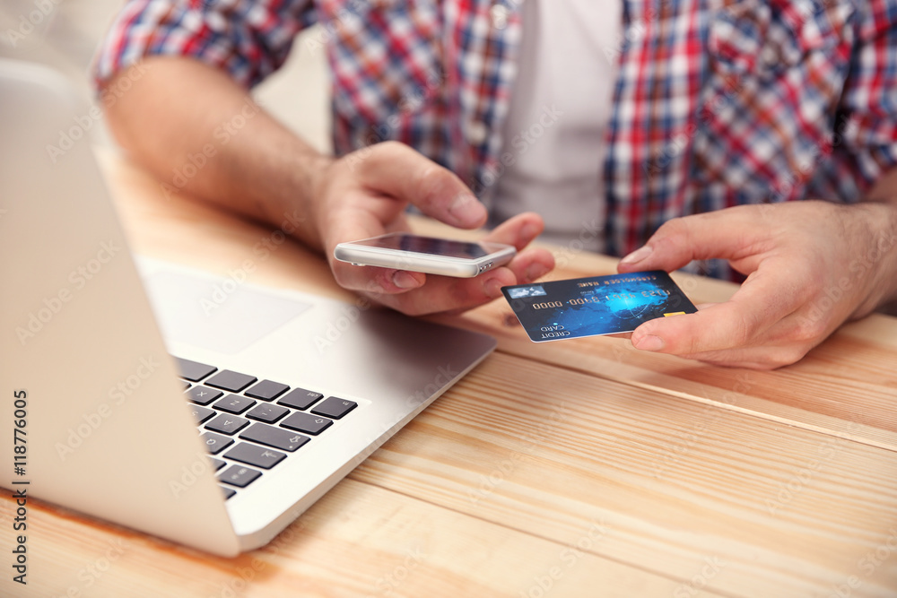 Man hands using credit card and phone for online shopping