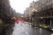 blurred view of road traffic in London on a rainy day through the bus window. raindrops on the glass window of the bus