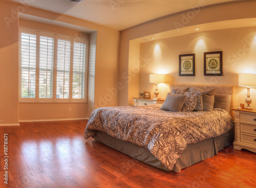 Fotografie, Obraz Irvine, CA, USA – August 19, 2016: Large master bedroom with recessed lighting, wood floors and feng shui decor
