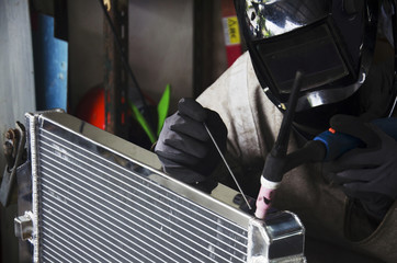 Thai people use electricity welding for fix and solder radiator