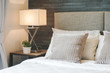© worldwide_stock - Hotel style bedding with white shade reading lamp