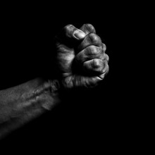 Clenched Fist On A Black Background
