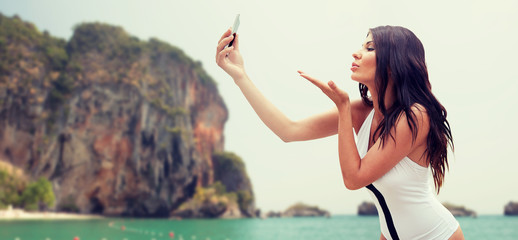 Wall Mural - young woman taking selfie with smartphone