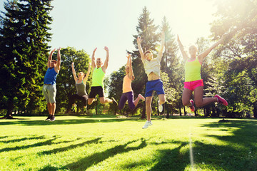 Poster - group of happy friends jumping high outdoors