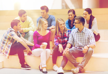 Canvas Print - group of smiling students with paper coffee cups