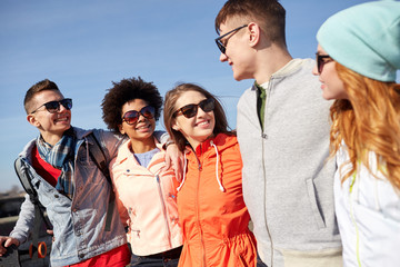 Poster - smiling friends in sunglasses laughing on street