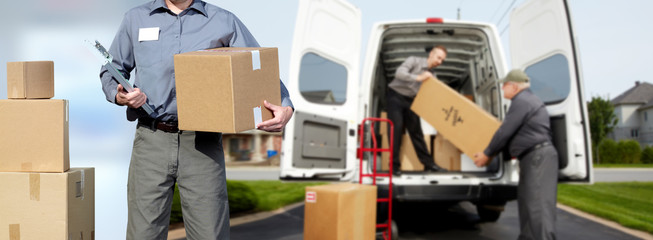 Delivery man near shipping truck.