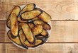 fried eggplant on the plate on rustic wooden background