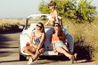 © nenetus - Three pretty young women driving on road trip on beautiful summe