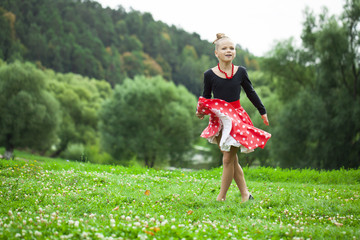 Wall Mural - Little girl in a beautiful dress dancing