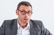 © STUDIO GRAND WEB - surprised middle aged businessman looking guilty and perplexed