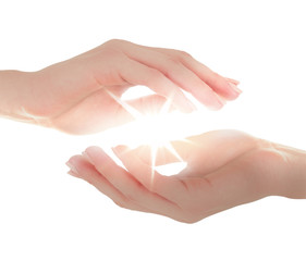 Female hands holding light on white background.