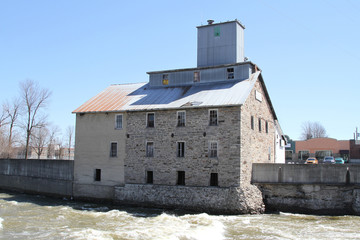 Old abandoned stone mill on a rushing river