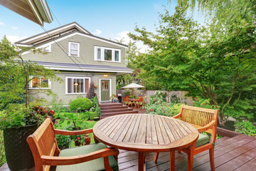 Back deck of guest house with wooden table set