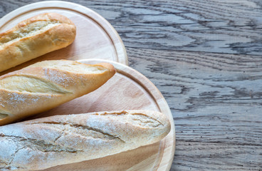 Canvas Print - Three baguettes on the wooden background