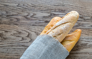 Poster - Three baguettes on the wooden background