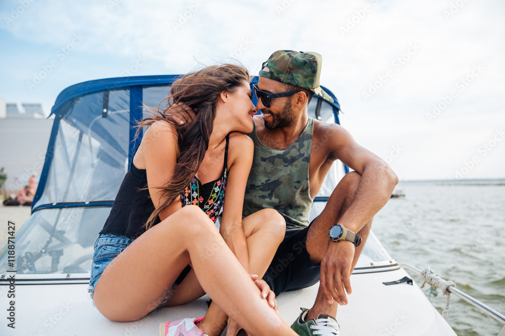 Couple hugging and kissing on boat Stock Photo | Adobe Stock