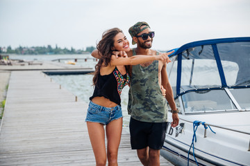 Poster - Portrait of romantic young couple standing at the wooden pier