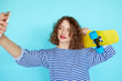 © kegfire - Hipster girl with skateboard making selfie