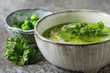 Pea soup puree in an old plate with parsley decoration. Stone sl