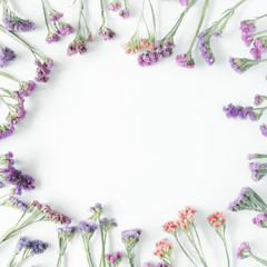 Wall Mural - frame with dried flowers on white background. autumn flat lay wallpaper, top view