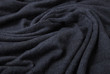 A full page of black fine knit fabric texture