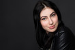 © Svyatoslav Lypynskyy - Closeup portrait of beautiful brunnette model woman smiling for camera while posing isolated on black background in studio.