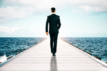 Businessman walking on pier