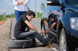 © torwaiphoto - Man changing tire That are leaking His car broke down en route t