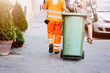 Worker Of Cleaning Company In Orange Uniform