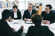 © DragonImages - Group of lawyers negotiations during pretrial settlement