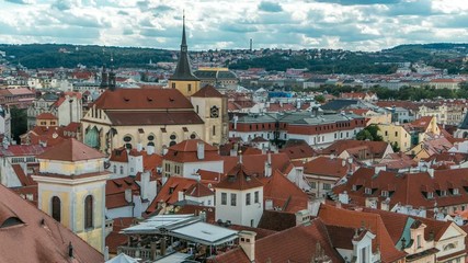 Wall Mural - Aerial timelapse view of the traditional red roofs of the city of Prague, Czech Republic with the church of St. Jilji