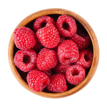 Raspberries In A Wooden Bowl On White Background. Red Ripe Berries Of Rubus Species. Edible Fruits, Raw, Organic And Vegan Food. Isolated Macro Photo Close Up From Above.