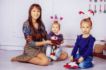 mother and two daughters in the room. The concept of New Year and Christmas