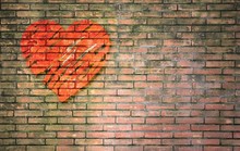 Red Heart Painted Effect On Old Brick Wall