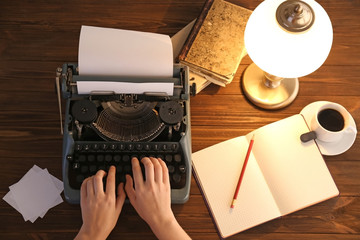 Wall Mural - Woman typing on the typewriter, top view