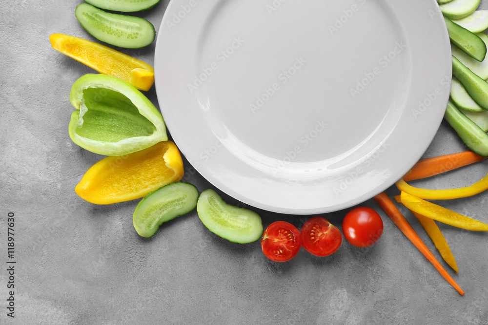 Empty plate with sliced vegetables on table