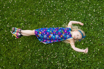 girl a girl lies on a grass in beautiful clothes