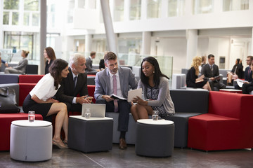 Wall Mural - Businesspeople Meeting In Busy Lobby Of Modern Office