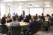 © Monkey Business - Delegates Applauding Businesswoman Making Presentation