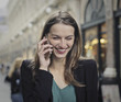 © olly - Smiling woman doing a phone call