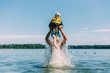 © Amanda O'Donoughue - Small child being lifted out of water by male adult