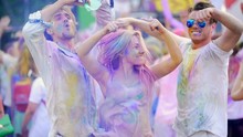 Cheerful Young People Throwing Colorful Powder In Air, Dancing At Festival