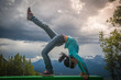 Young asian girl in bridge pose at Lake Louise Area