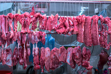 Hanging Pork And Meat At Butcher Shop Stall At Fresh Food Market In Asia, Freshly Slaughtered Meat May Be Easily Found On The Streets Of Hong Kong, Where People Usually Buy It Directly From Butcher