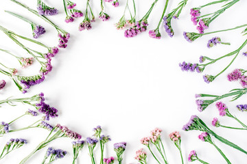 Wall Mural - frame with dried flowers on white background. autumn flat lay wallpaper, top view