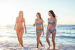 © kurapatka - three girls having fun on beach, friends on beach in sunset light