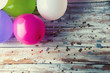 Colorful balloons on white vintage table. Copyspace